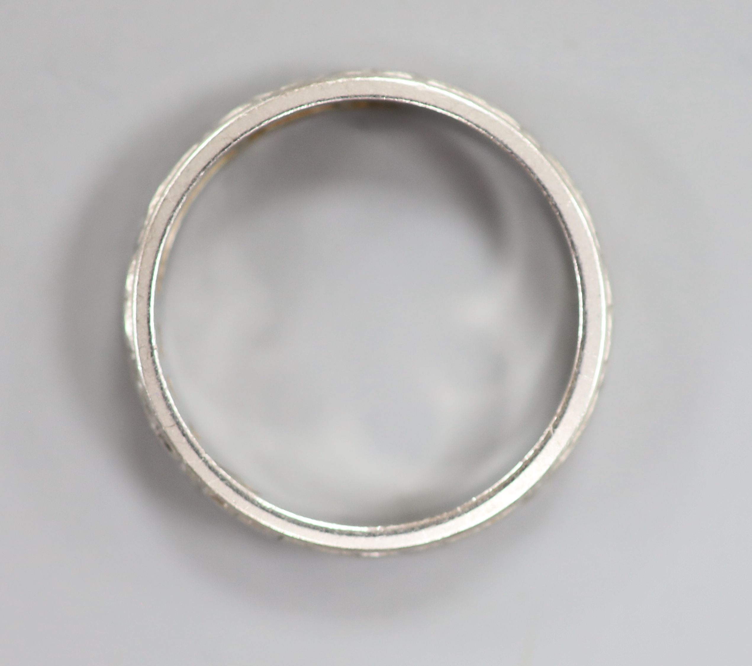 An engraved white metal(stamped platinum) wedding band, size L,